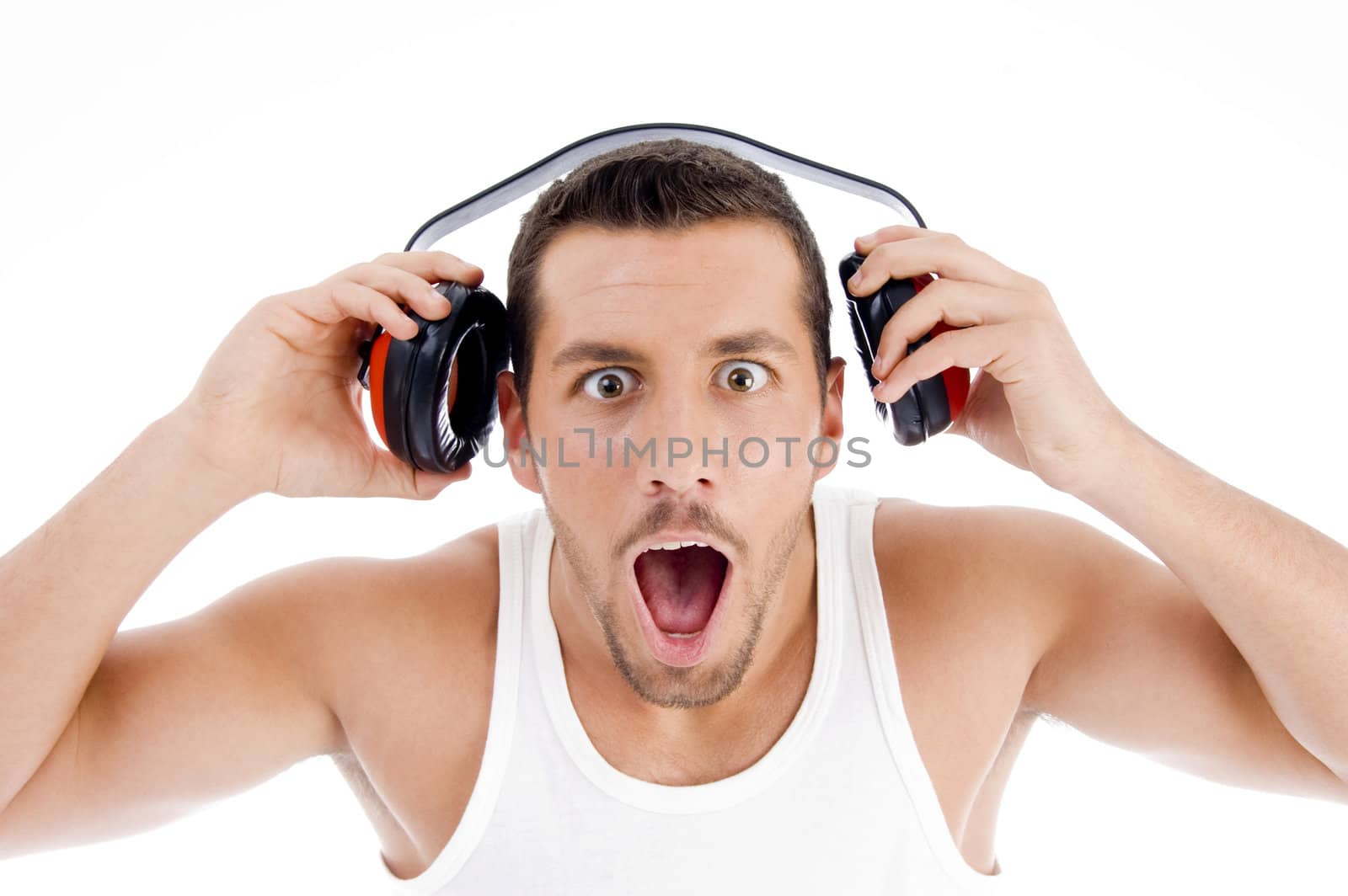 astonished male listening music on headphone with white background