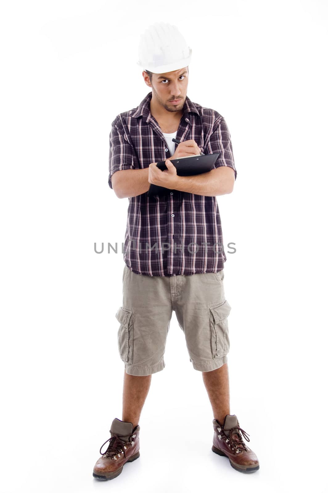 standing male engineer writing on pad on an isolated background