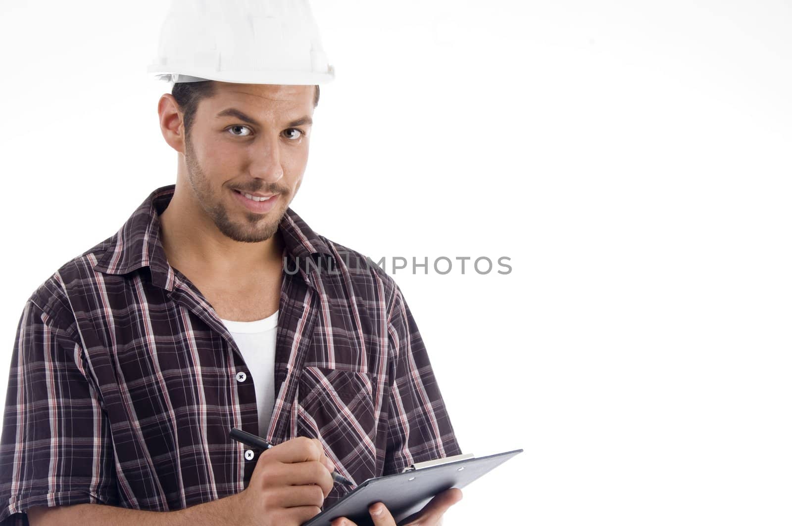 engineer writing on pad and looking at camera on an isolated white background