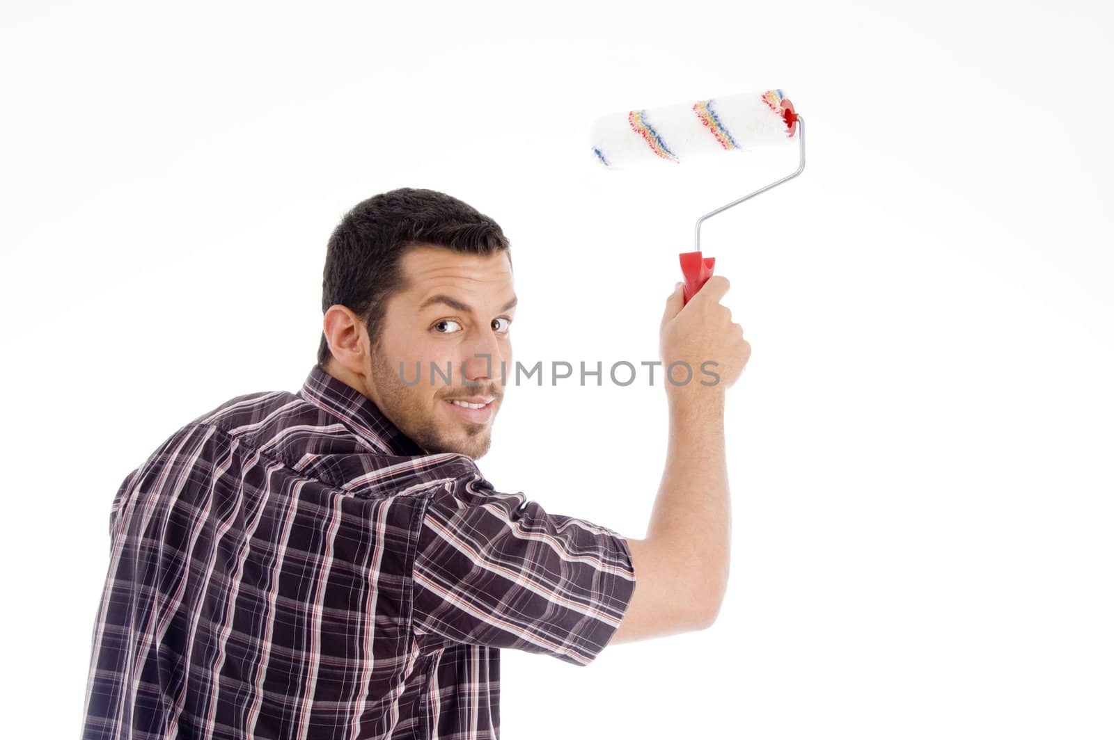 male looking backward while using roller brush with white background