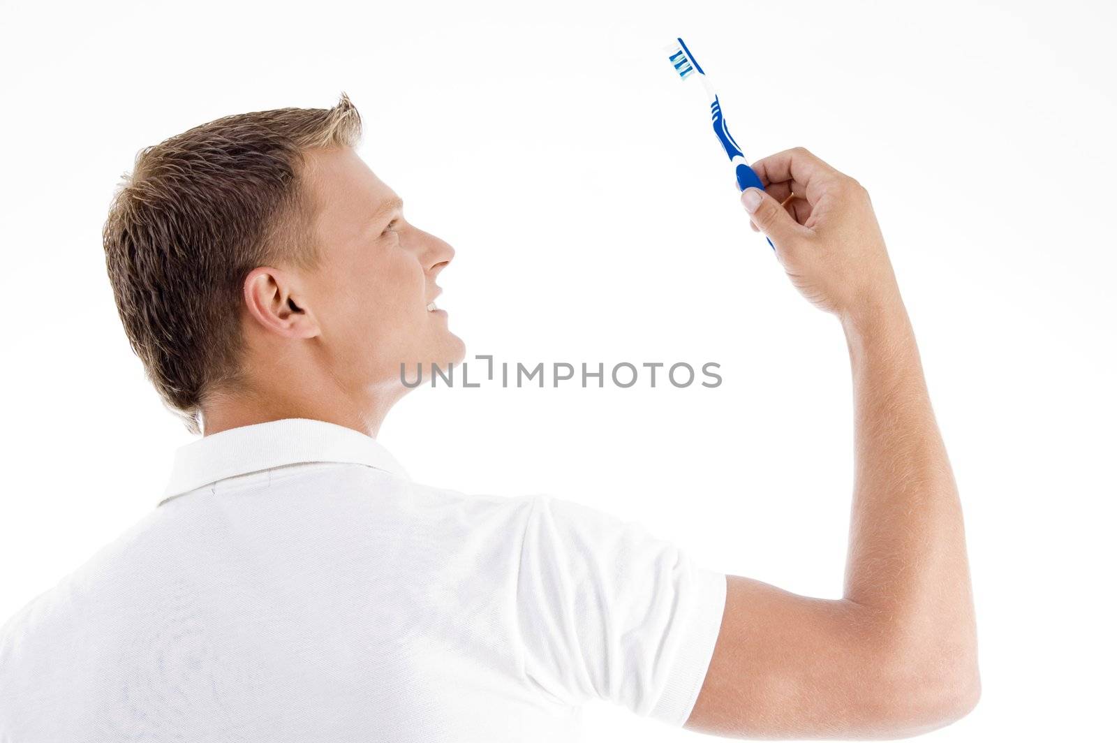 male looking at toothbrush on an isolated background