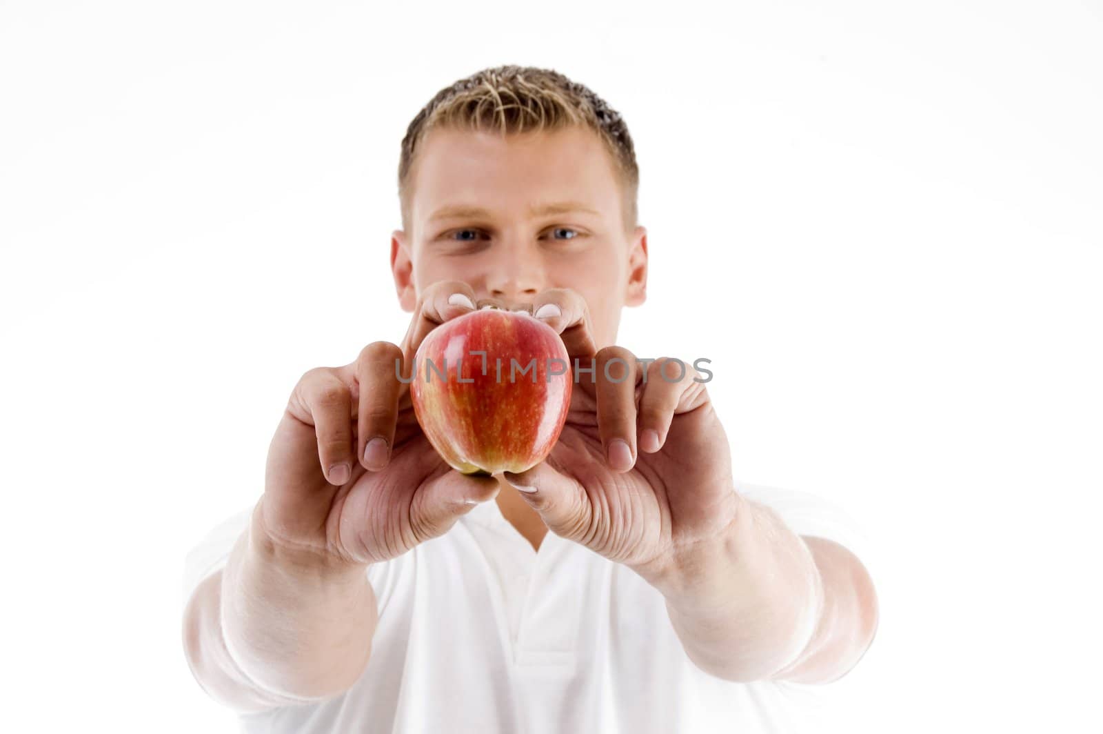 male holding apple with both hands on an isolated background