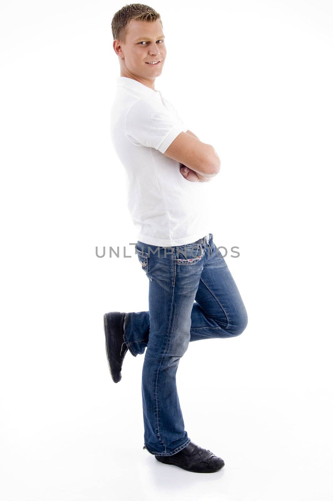 handsome man standing on one leg against white background