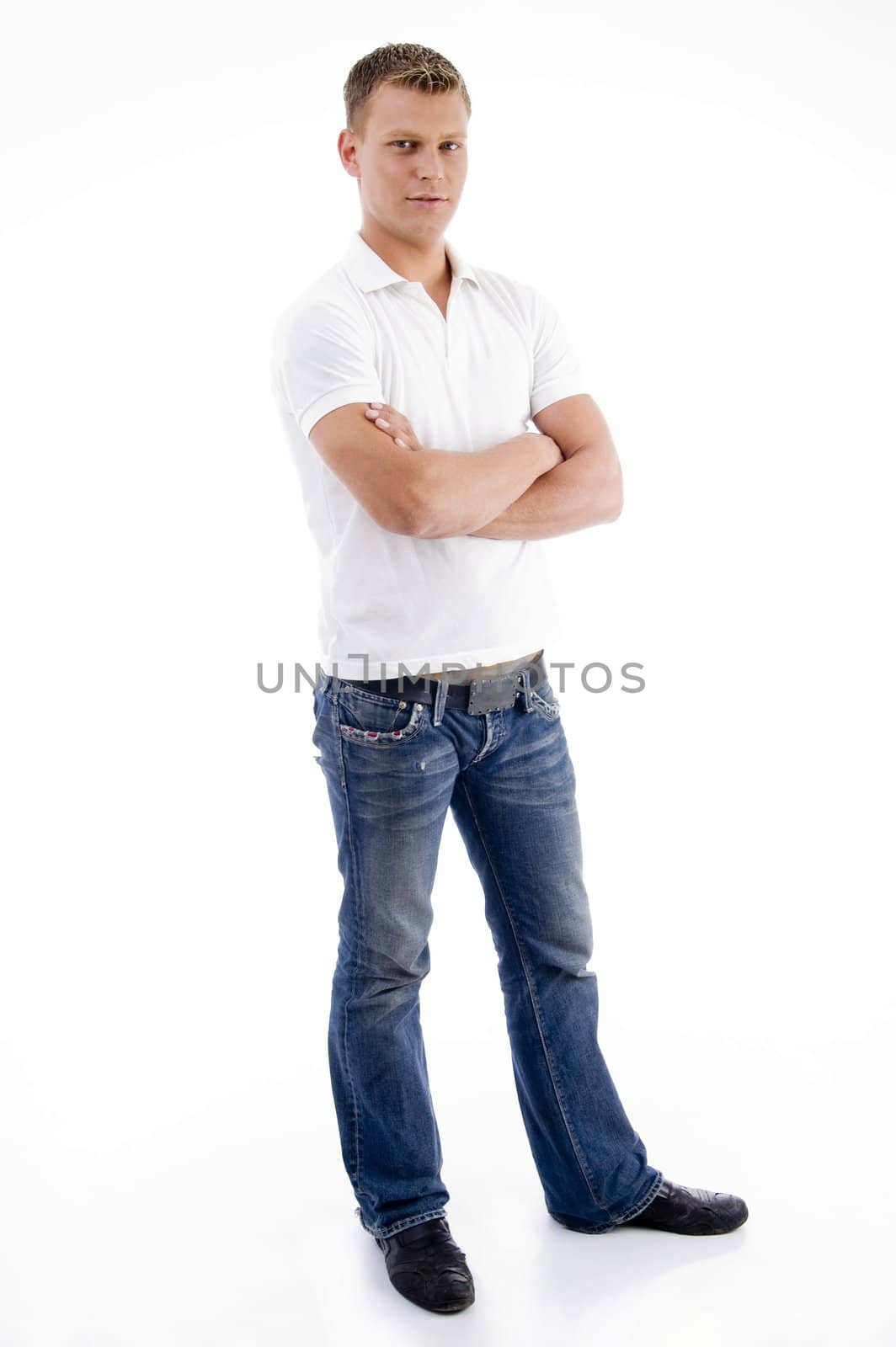 male standing with folded arms against white background