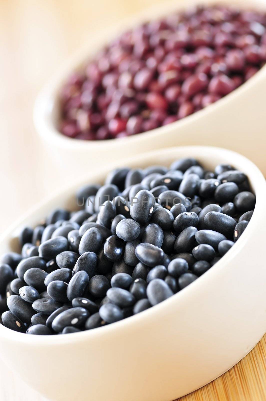 Dry black and red adzuki beans in bowls