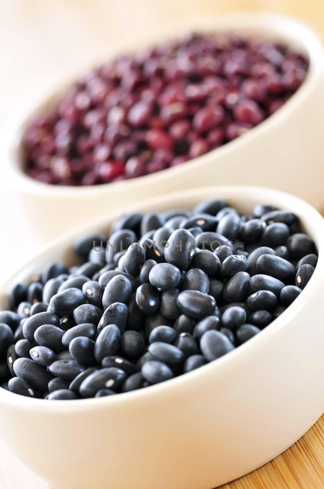 Dry black and red adzuki beans in bowls