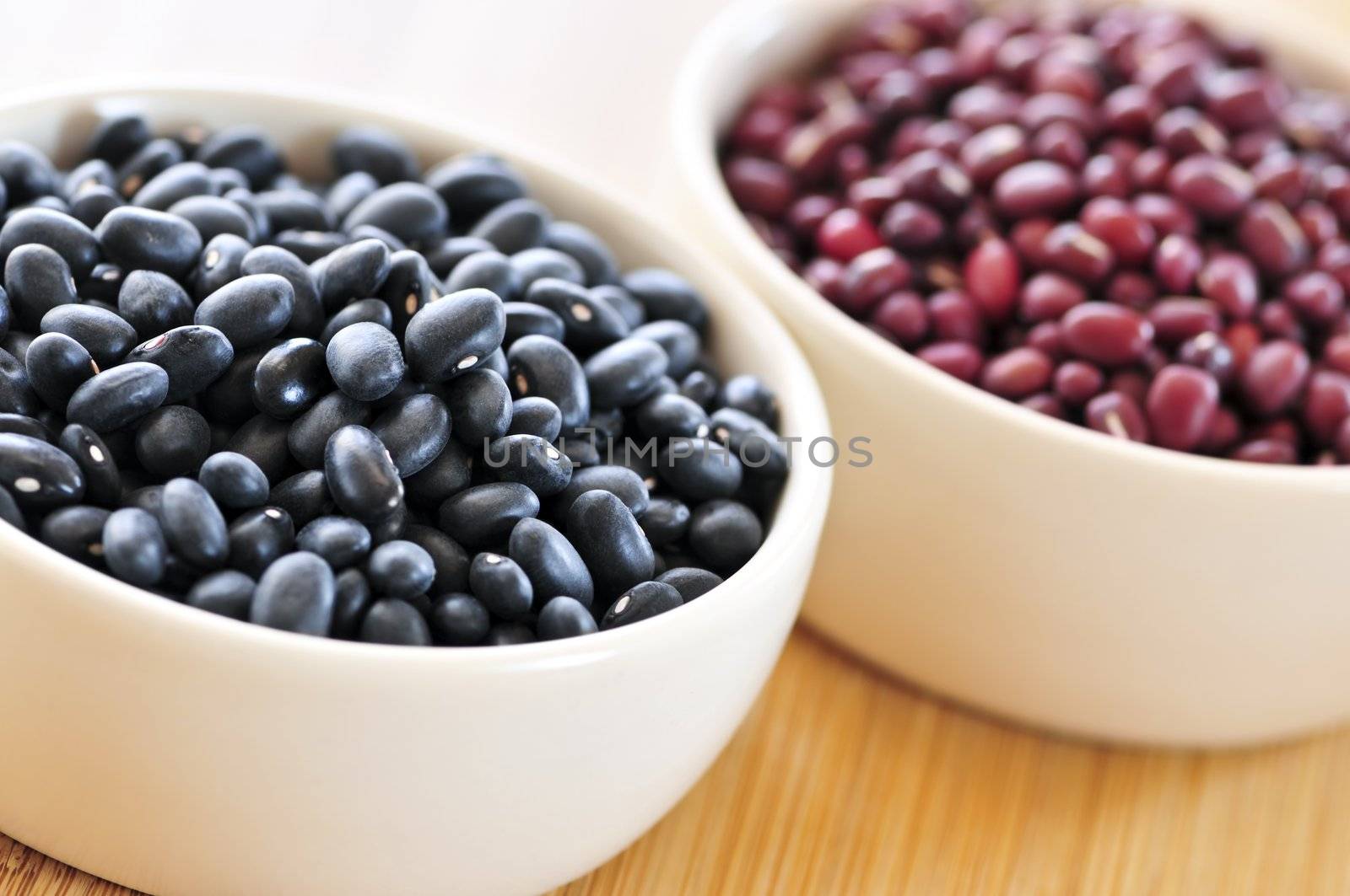 Dry black and red adzuki beans in bowls