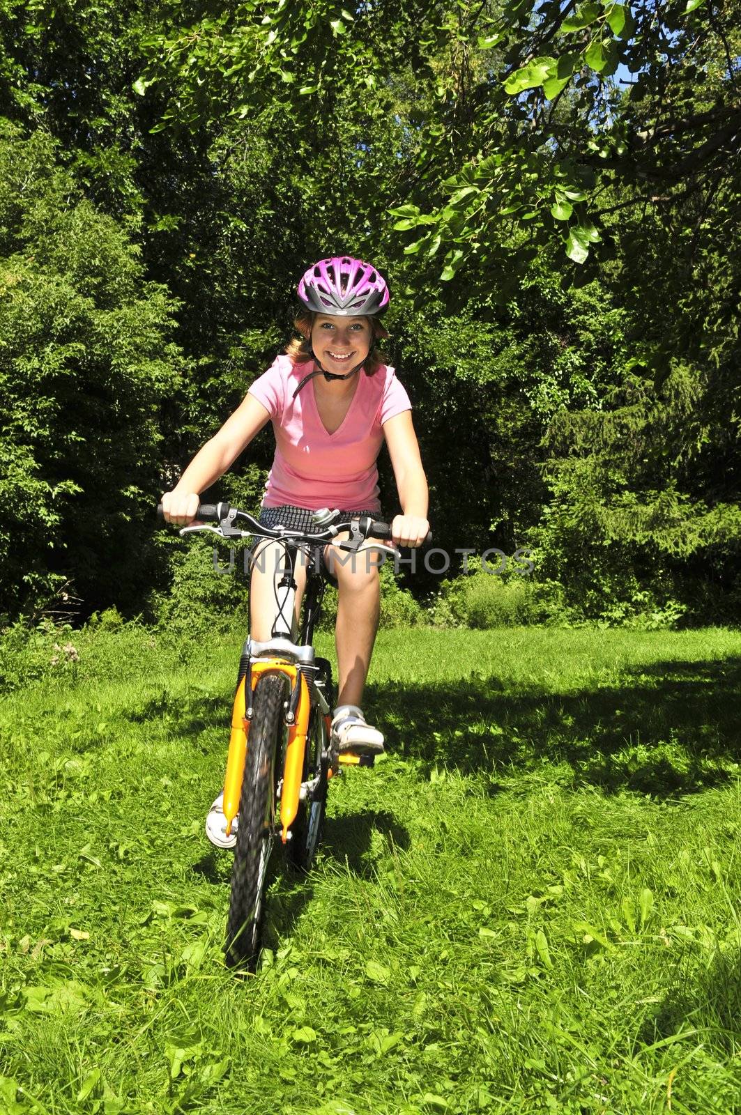 Teenage girl on a bicycle by elenathewise