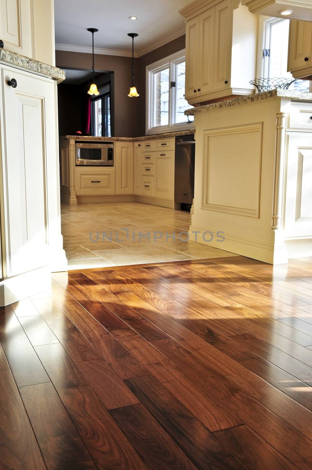 Hardwood and tile floor in residential home kitchen and dining room