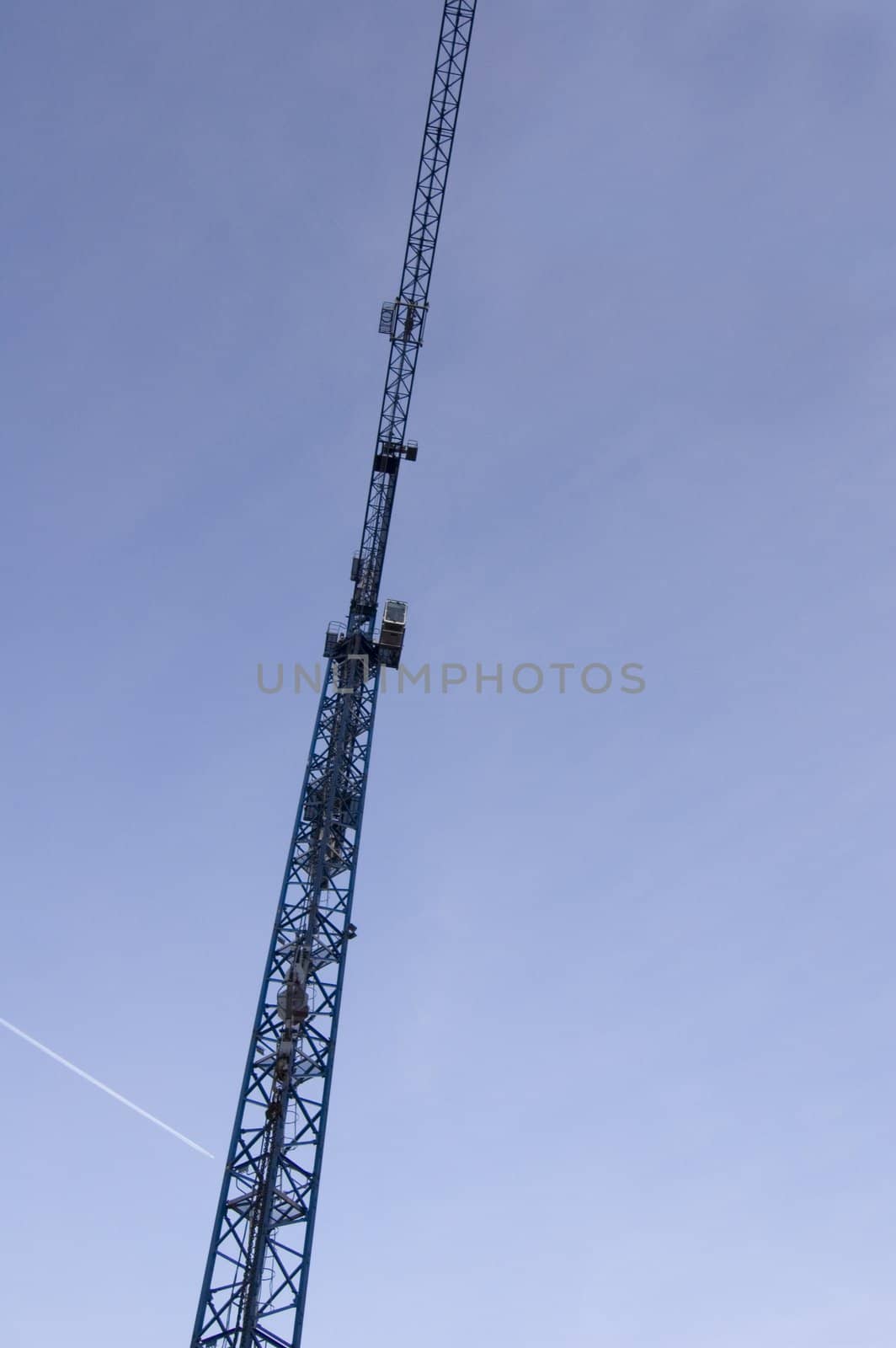 big blue crane on the sky background