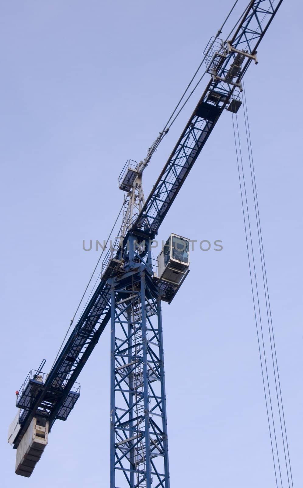 big blue crane on the sky background