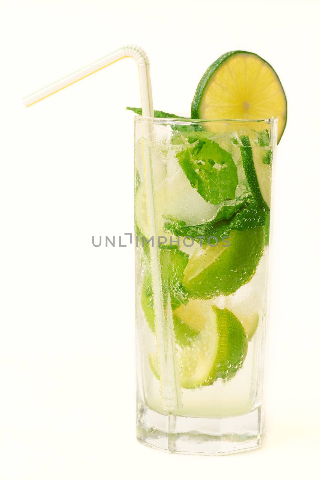 Drink with lime slices, ice and mint isolated on white