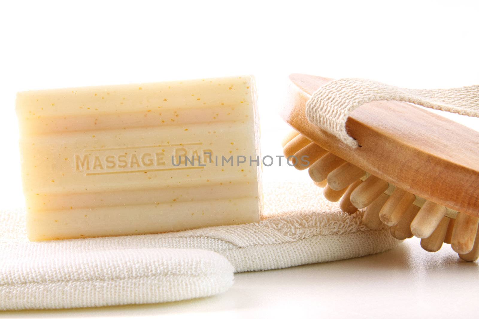 Natural soap with bath accessories on white background