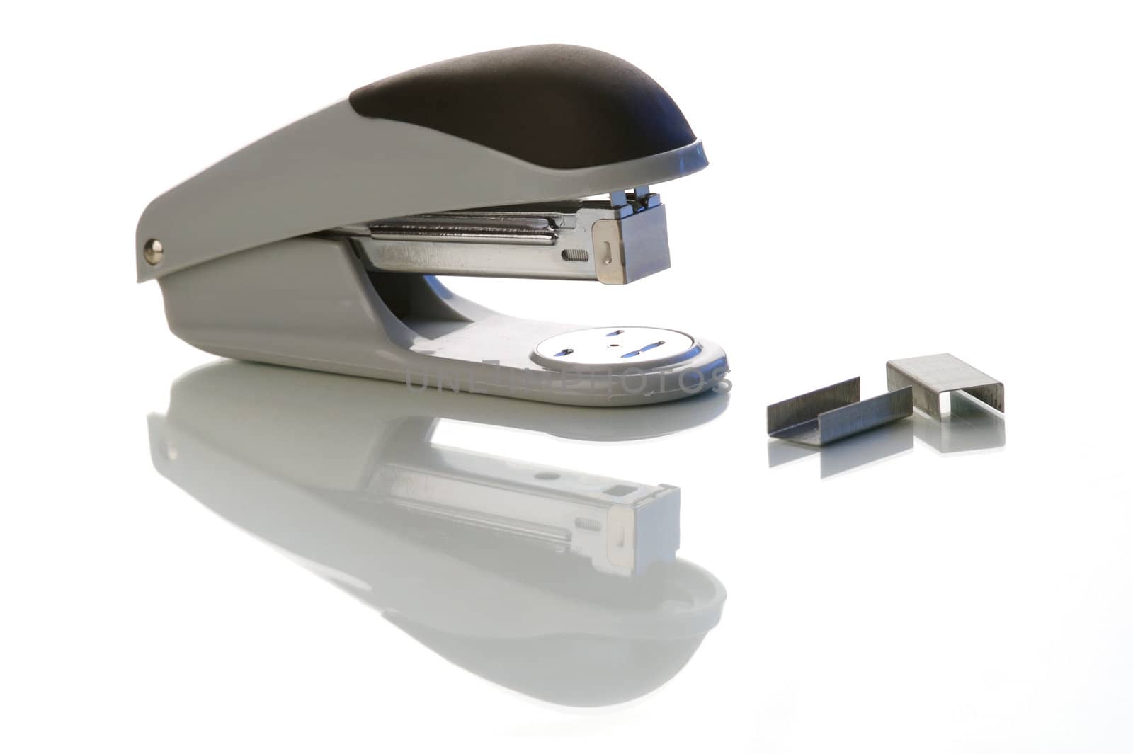 An office stapler on a white background