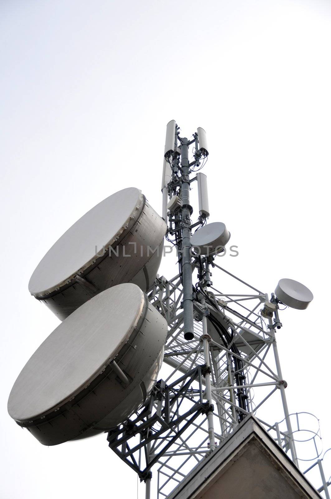 Communication tower with satellite dishes and aerials