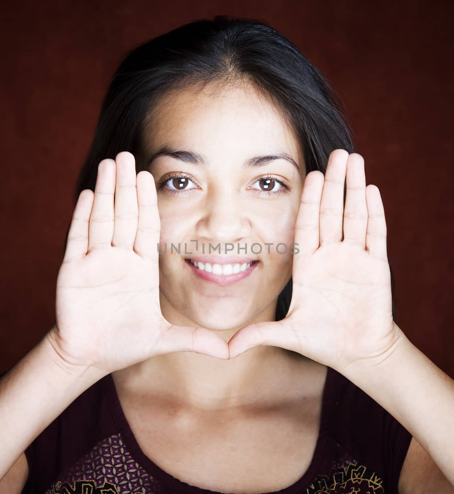 Pretty woman framing her face with her hands