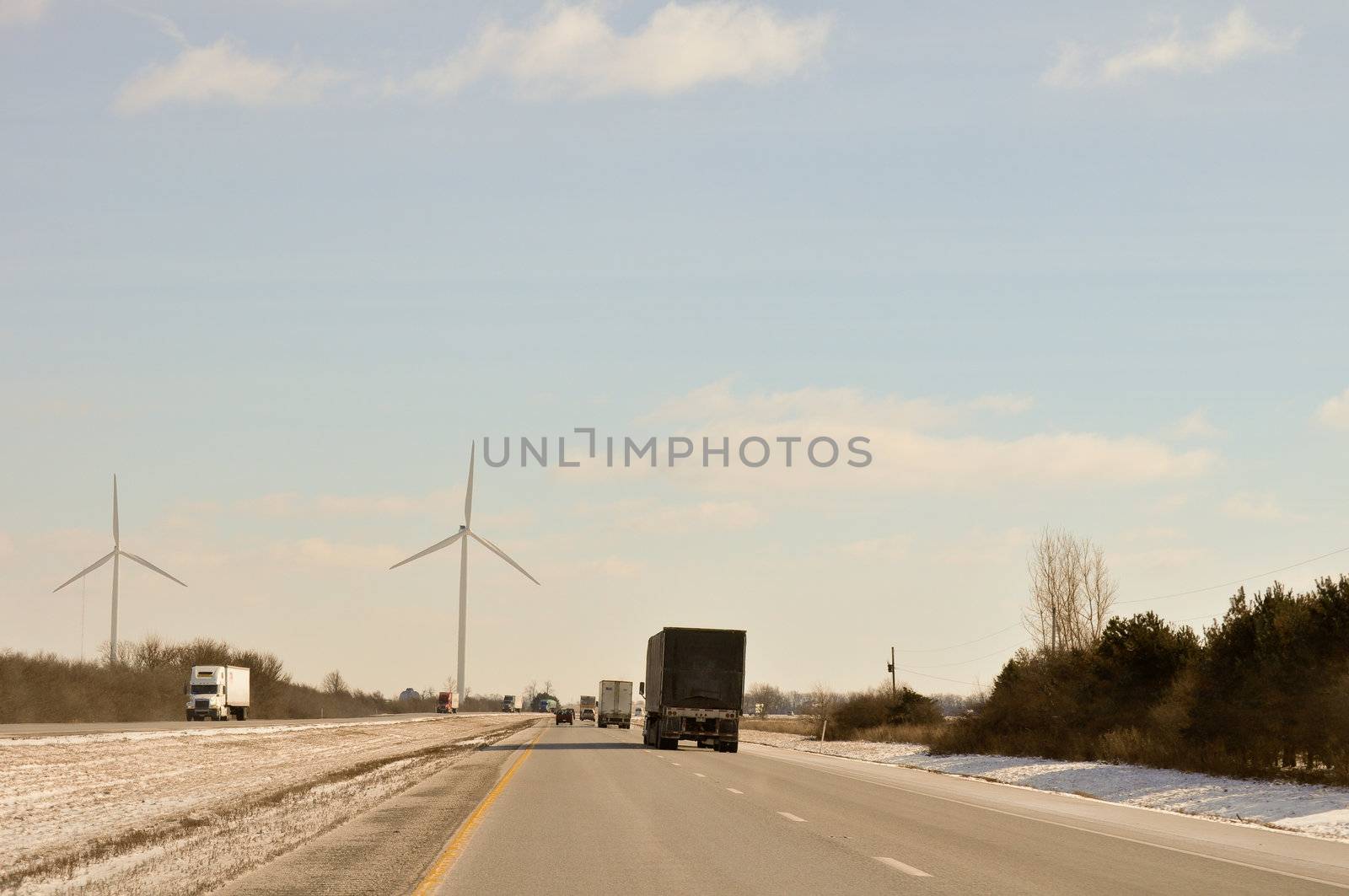 Indiana Wind Turbines loom over the highway by RefocusPhoto