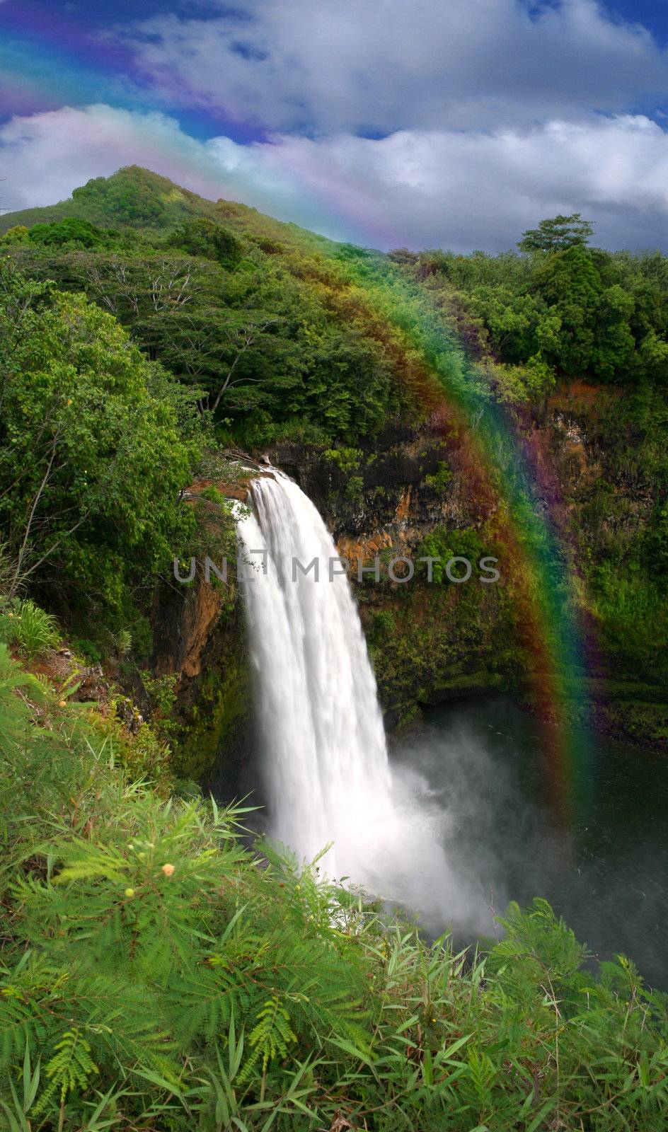 Waterfall in Kauai Hawaii With Rainbow by tobkatrina