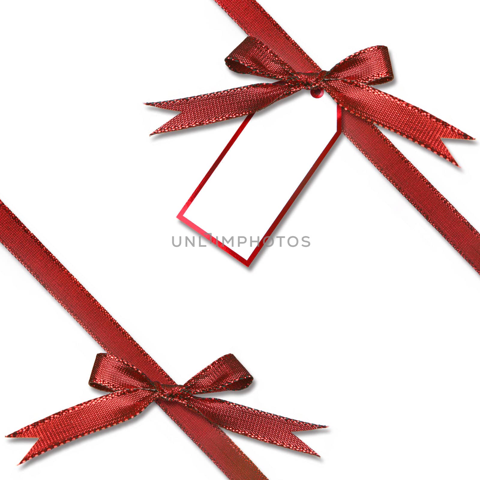 Christmas Gift Tag Hanging from a Present With Tied Red Bow