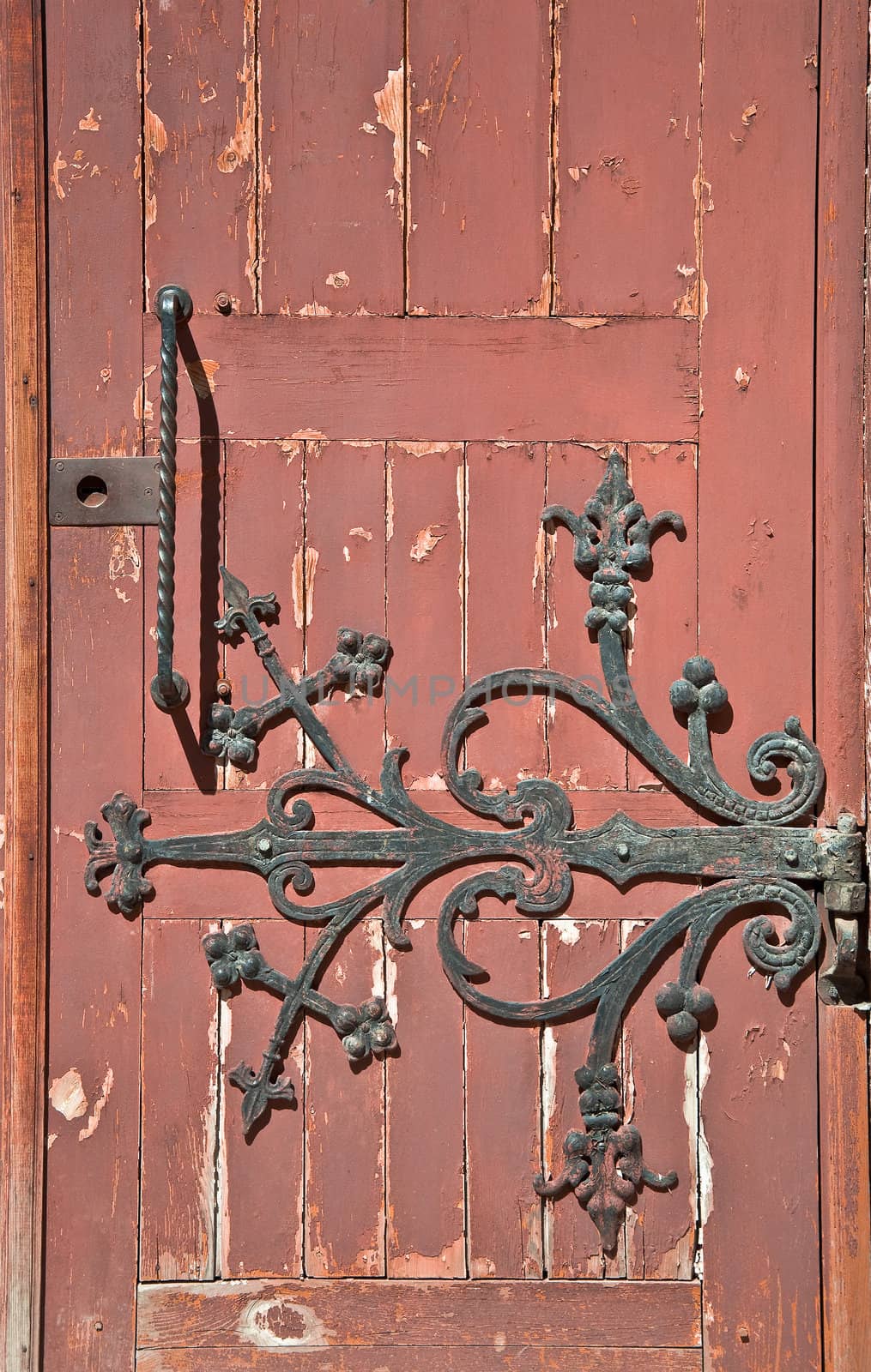 Detail of old wooden door with wrought iron handle. Close-up detail of the architecture.