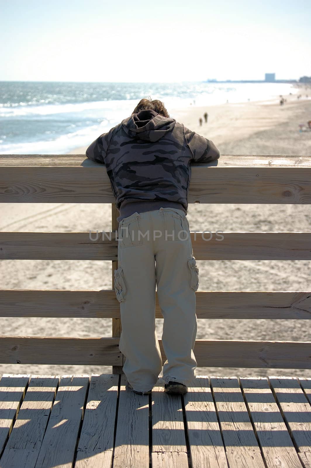 Boy Looking Out At Beach by RefocusPhoto