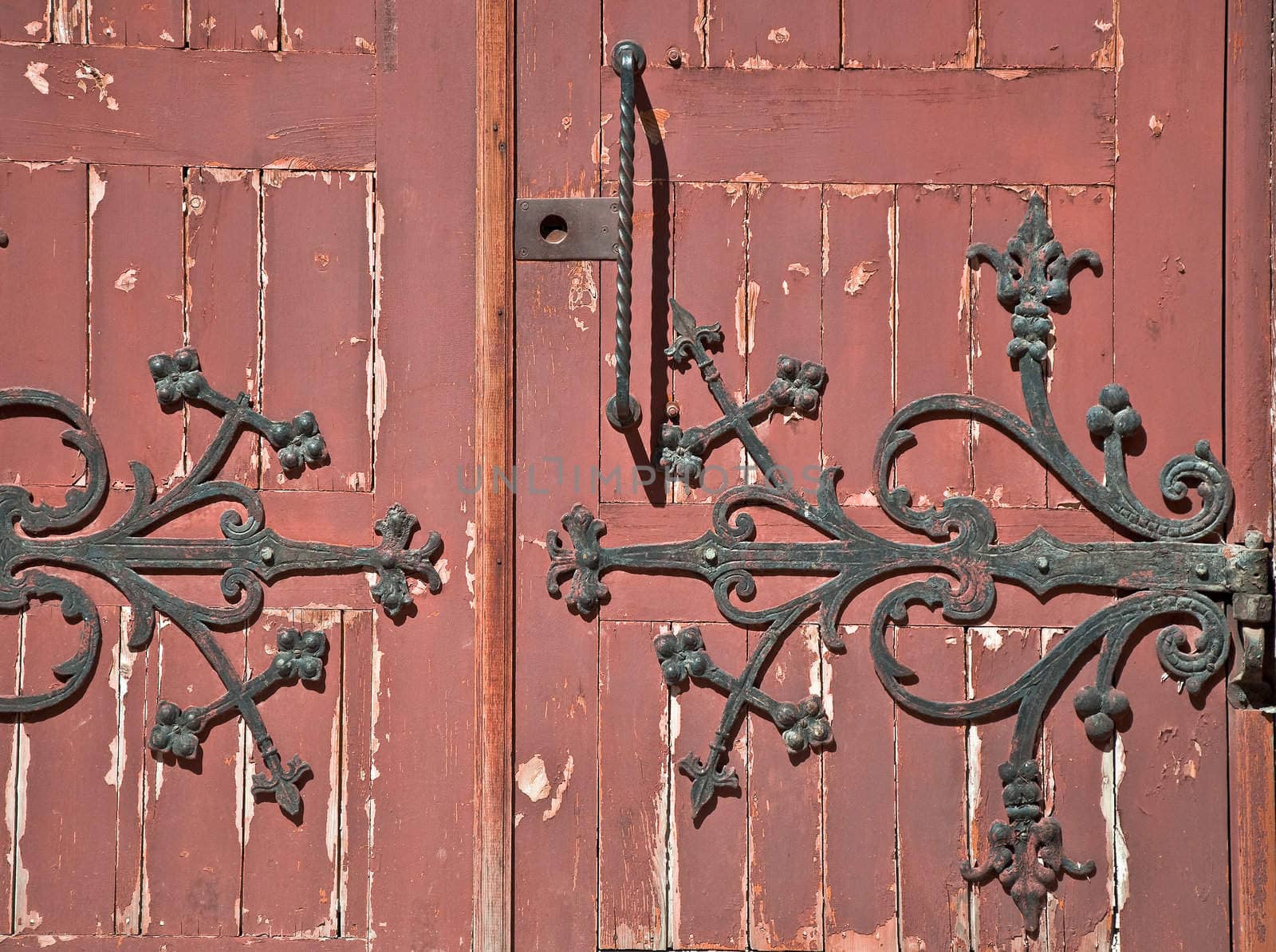 Detail of old wooden door with wrought iron handle. Close-up detail of the architecture.