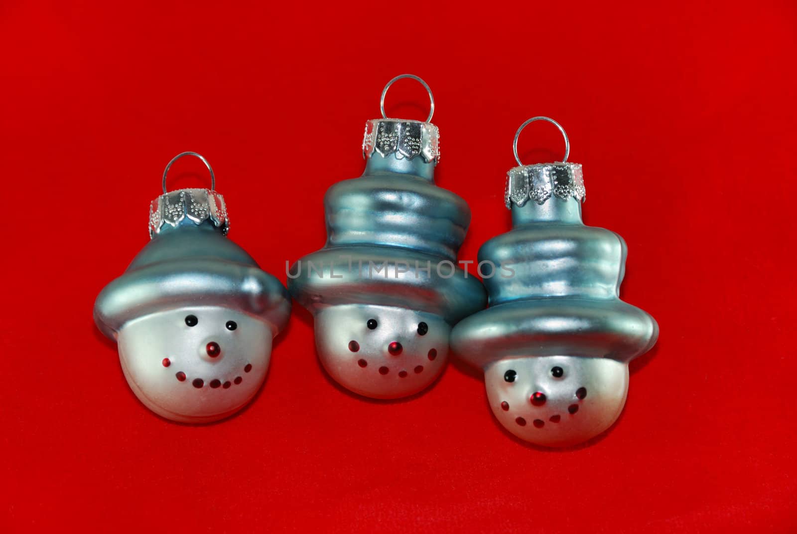 Three Christmas Tree Decoration Snowmen on Red Background