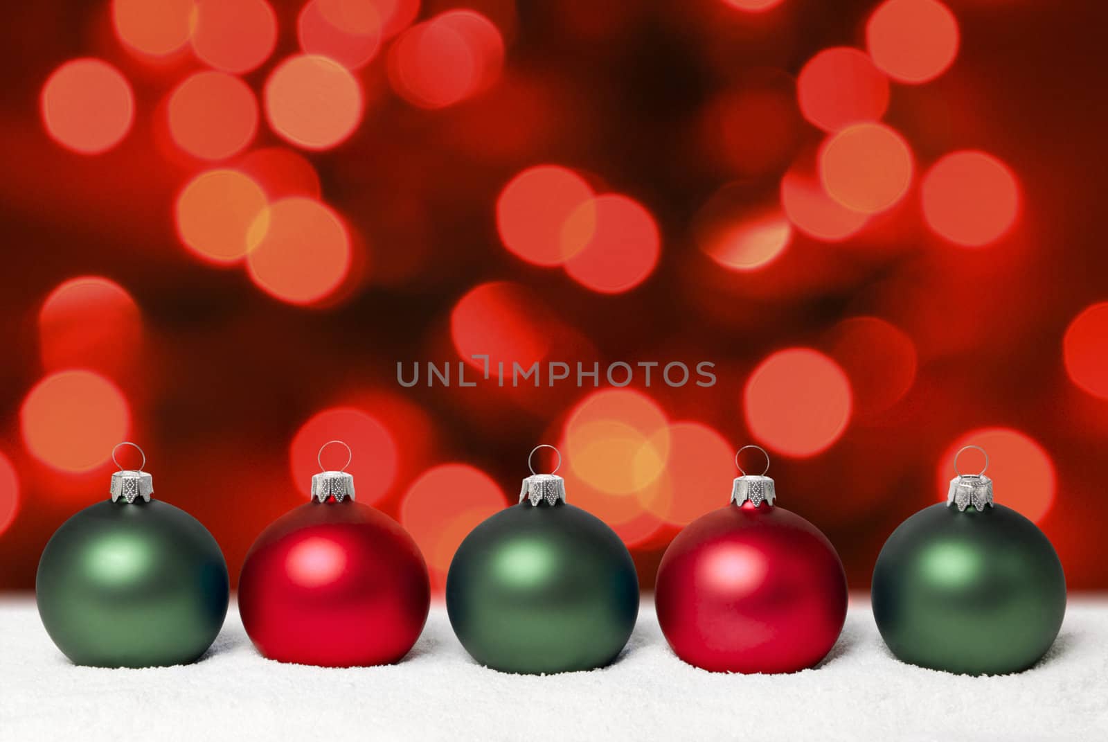 Christmas balls on the snow. Blurred red christmas lights. aRGB.