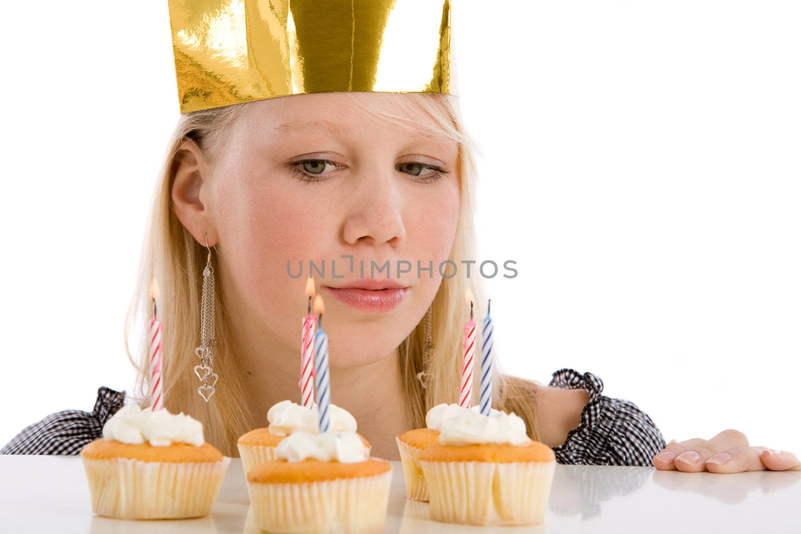 Young blond girl with birthday cakes and candle