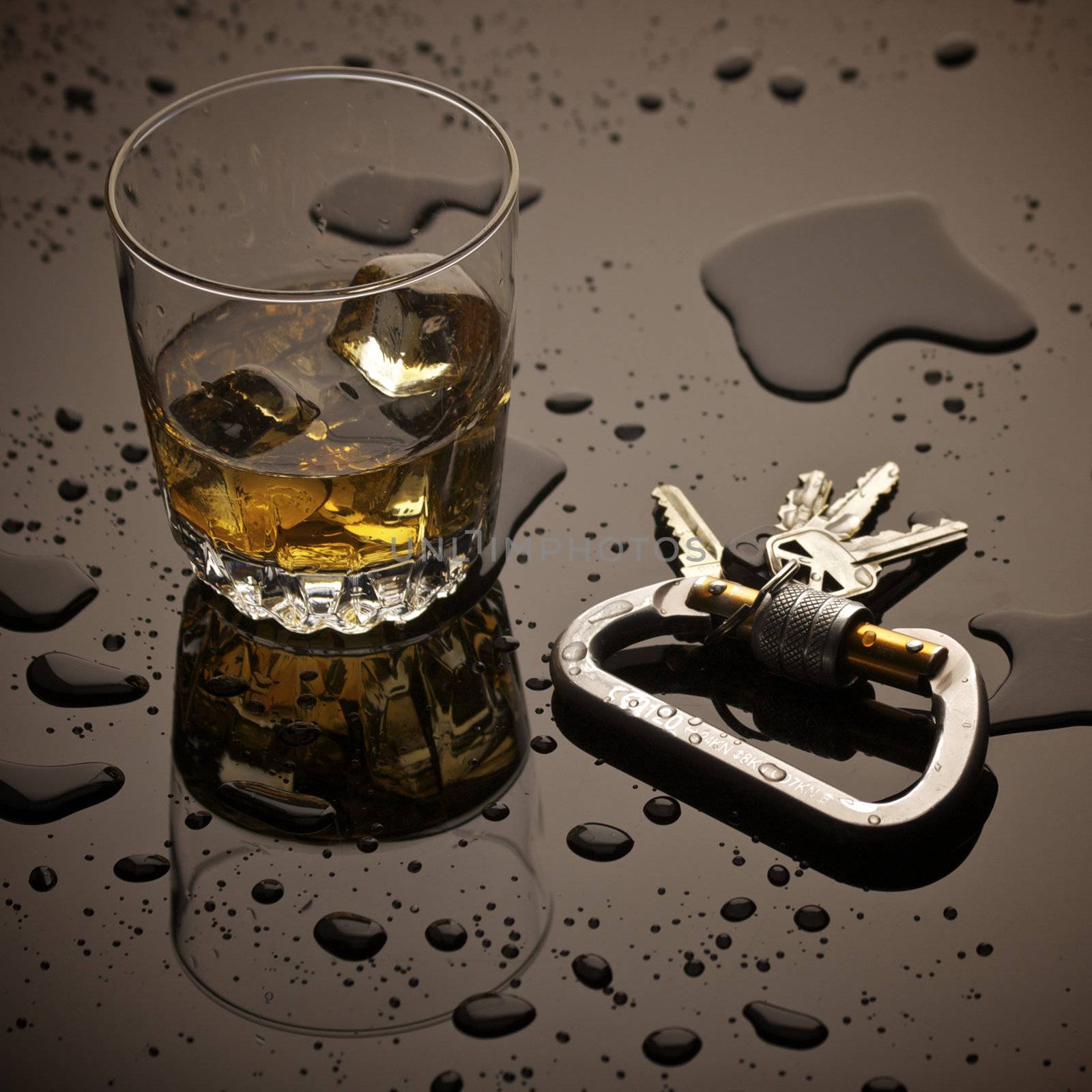 Hard Liquor and Car Keys sitting on a Bar with Spilled Liquid.