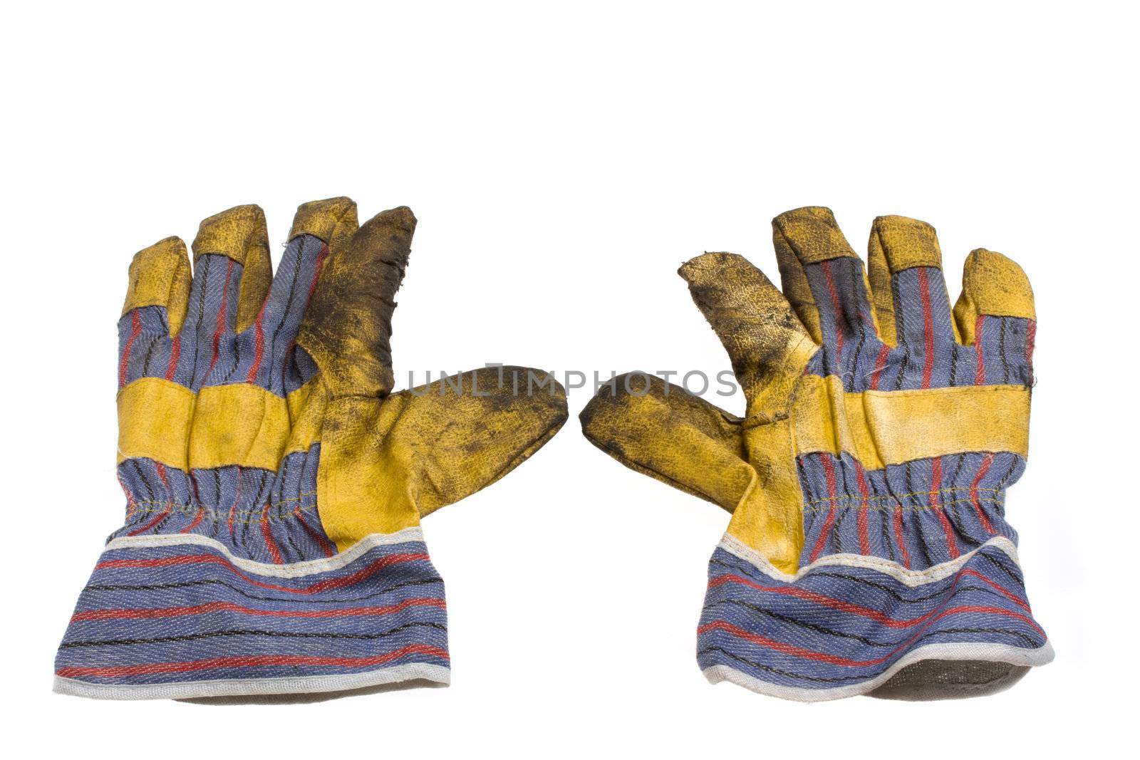 a pair of dirty used work gloves isolated on white background by bernjuer