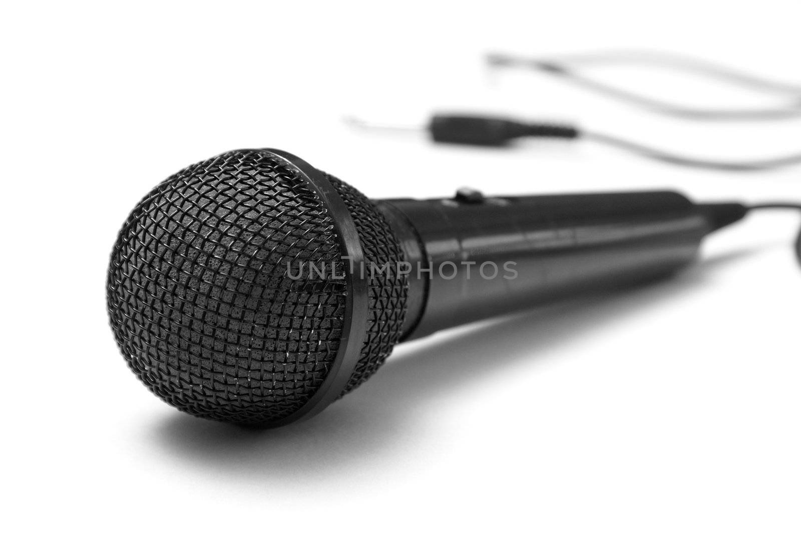 A macro shot of a microphone over a white background.