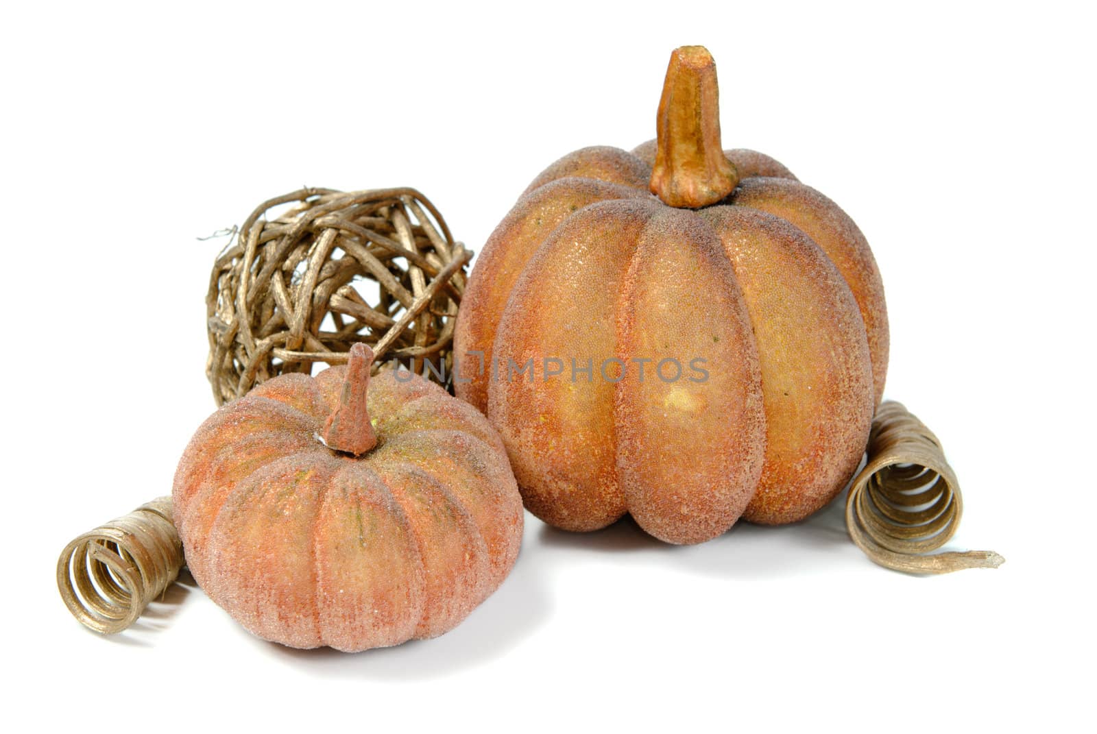 Artificial pumkins and fall ornaments, isolated against a white background.