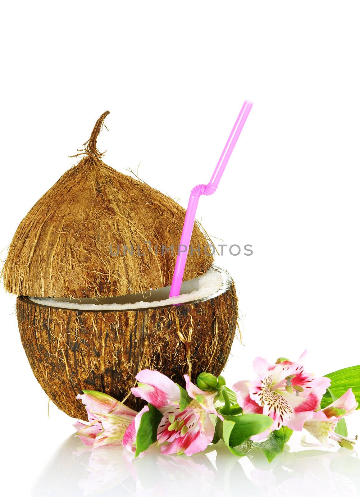 coconut stylized as glass for coctail with flowers over white