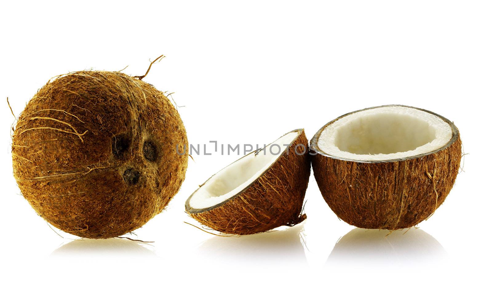 set of whole and cut coconuts over white background