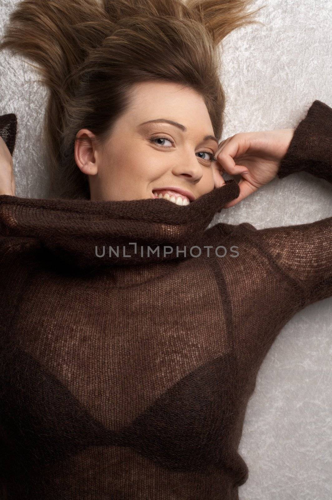 smiling woman in brown sweater
