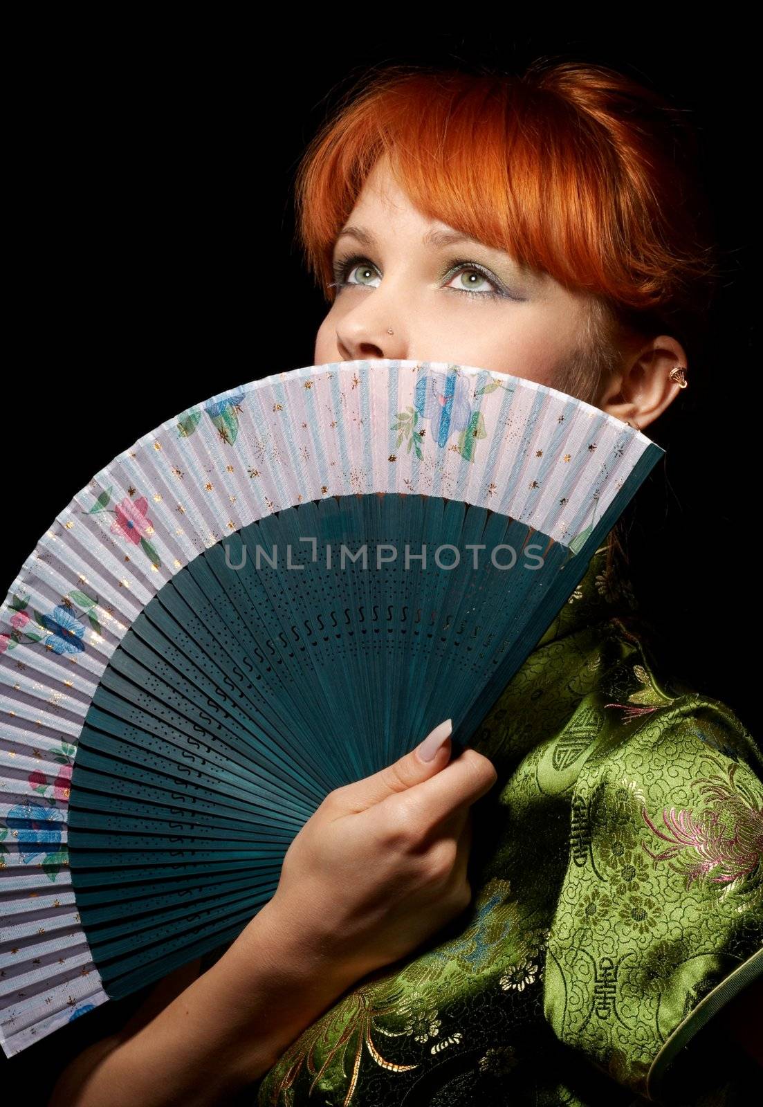 pretty redhead with green fan