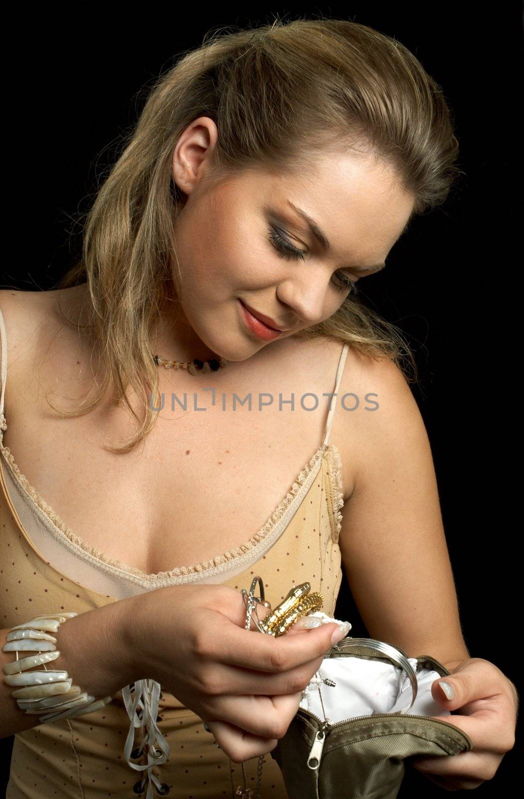 Pretty girl inspecting her hand-bag