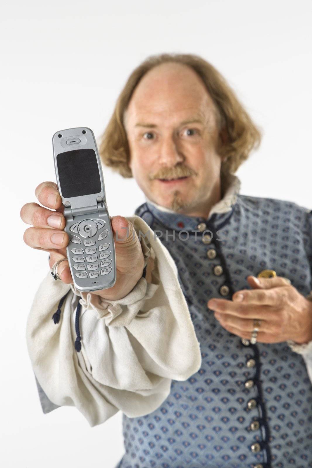 William Shakespeare in period clothing holding cell phone towards viewer.