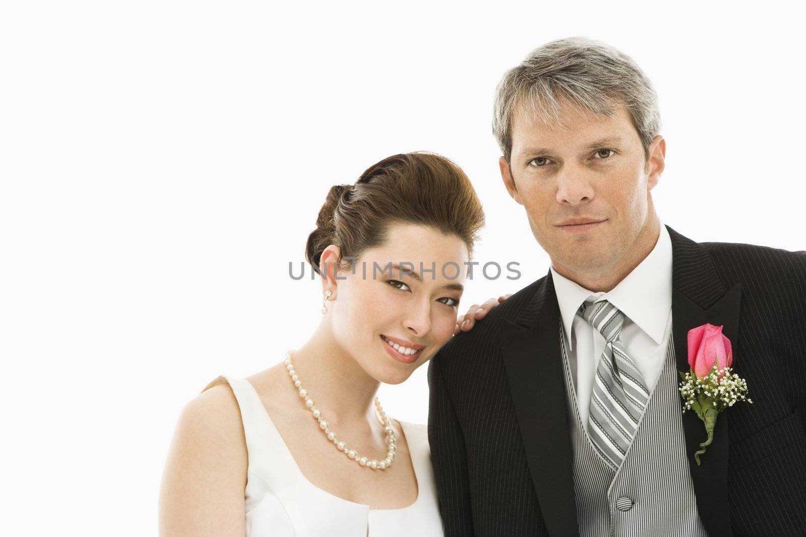 Portrait of Caucasian groom and Asian bride.