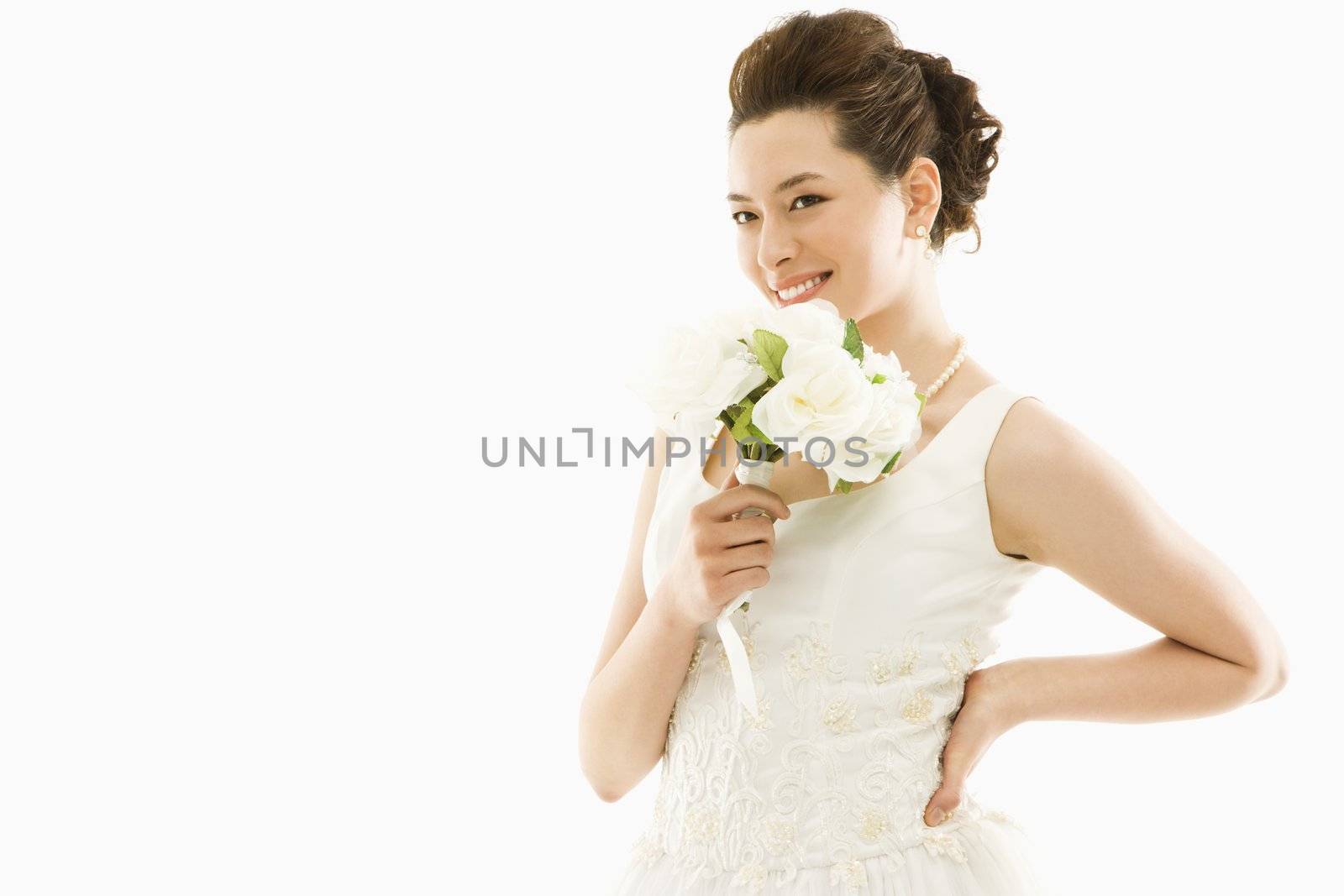 Portrait of Asian bride with bouquet.