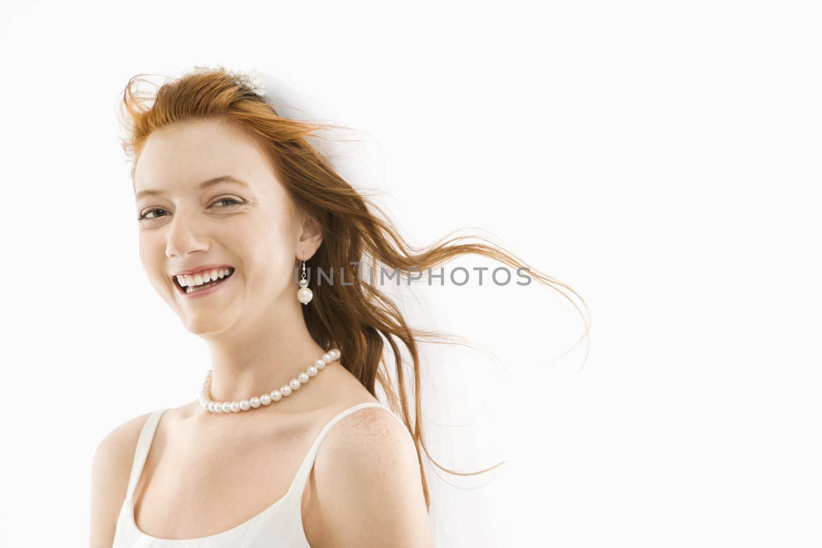 Portrait of Caucasian bride with blowing hair.