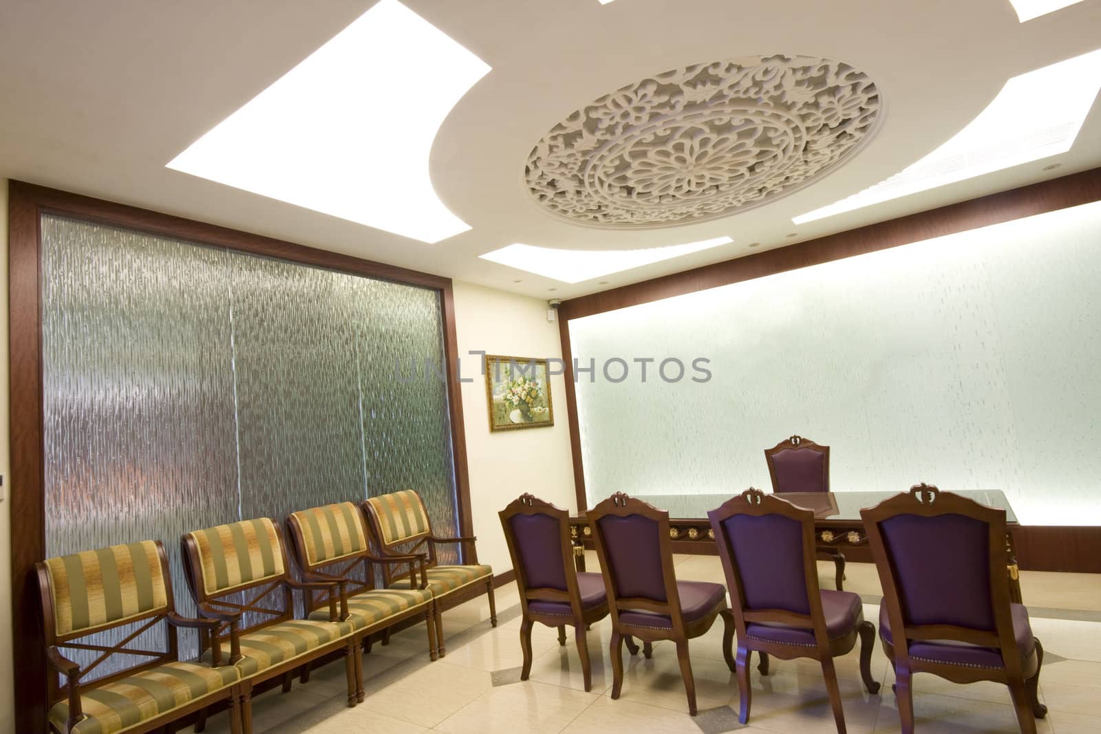 A large mahogany conference room table with leather chars
