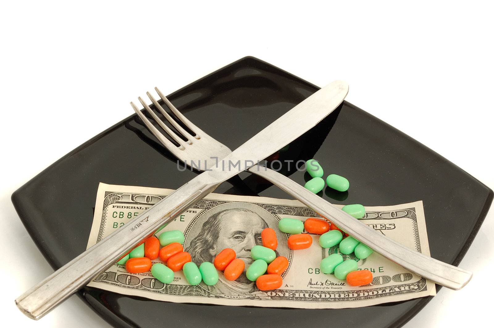 chemical diet - colored pills on black japanise plate