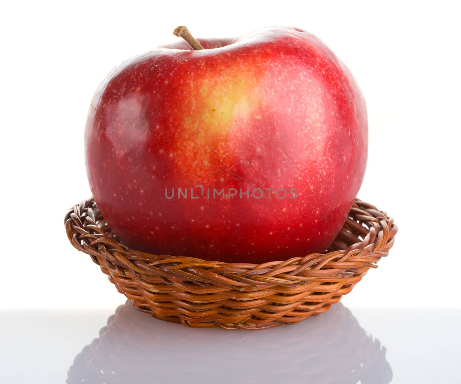 red apple in basket with reflection by Alekcey