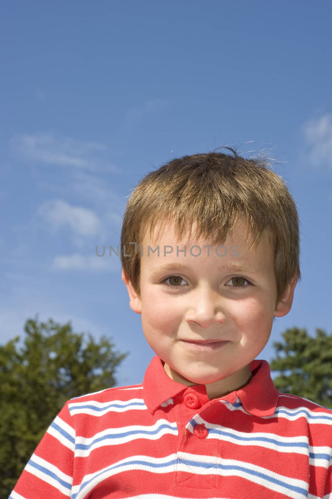 young smiling boy in red striped shirt by rongreer