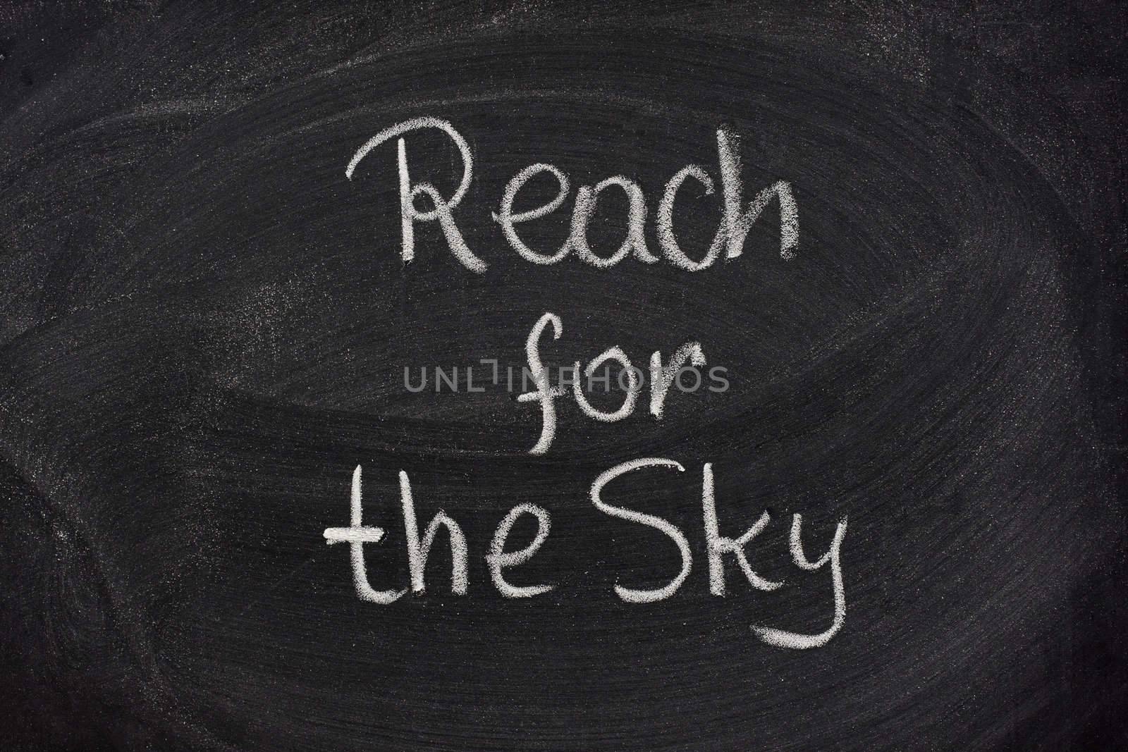 reach for the sky phrase on blackboard by PixelsAway