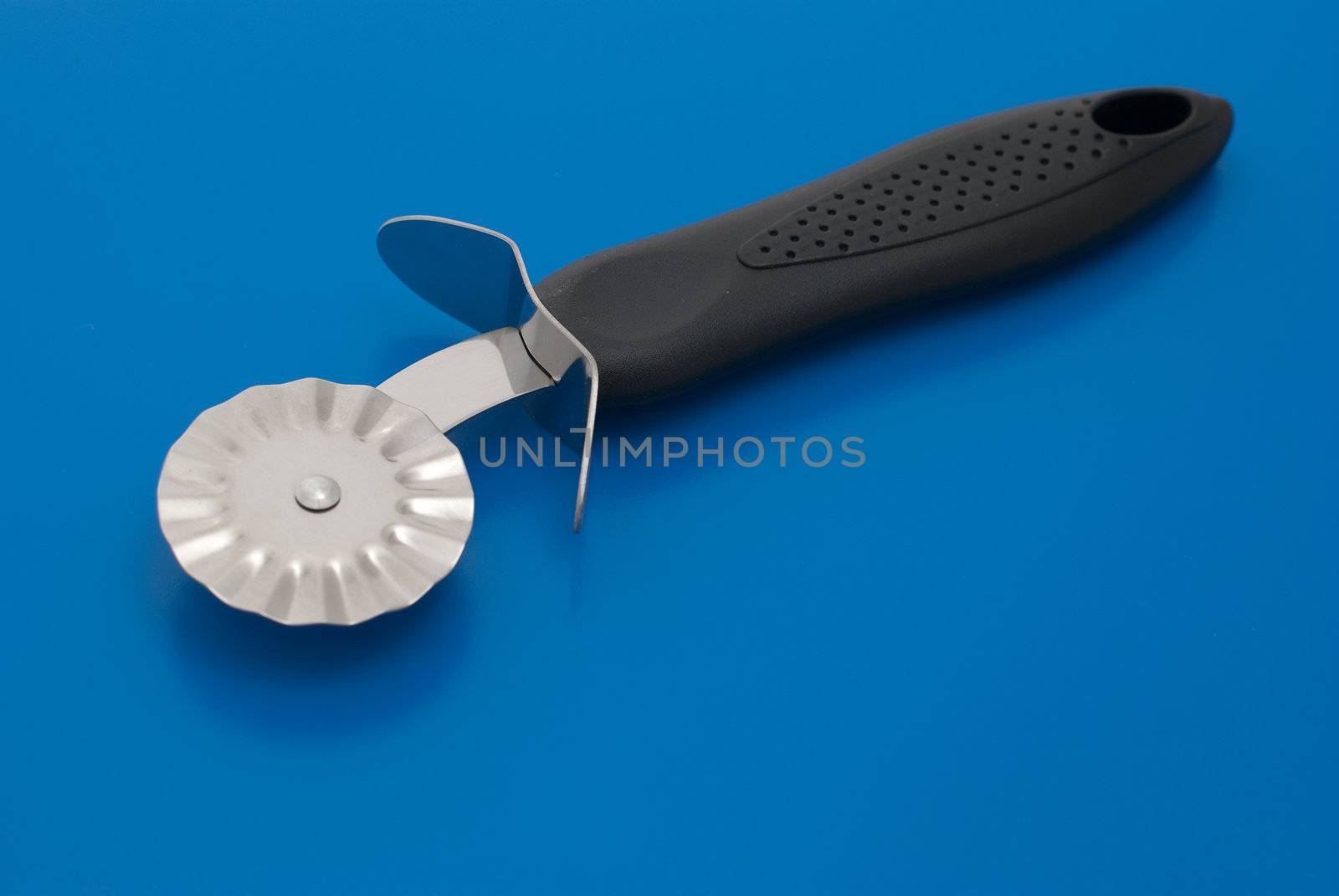 Pie knife isolated on the blue background.