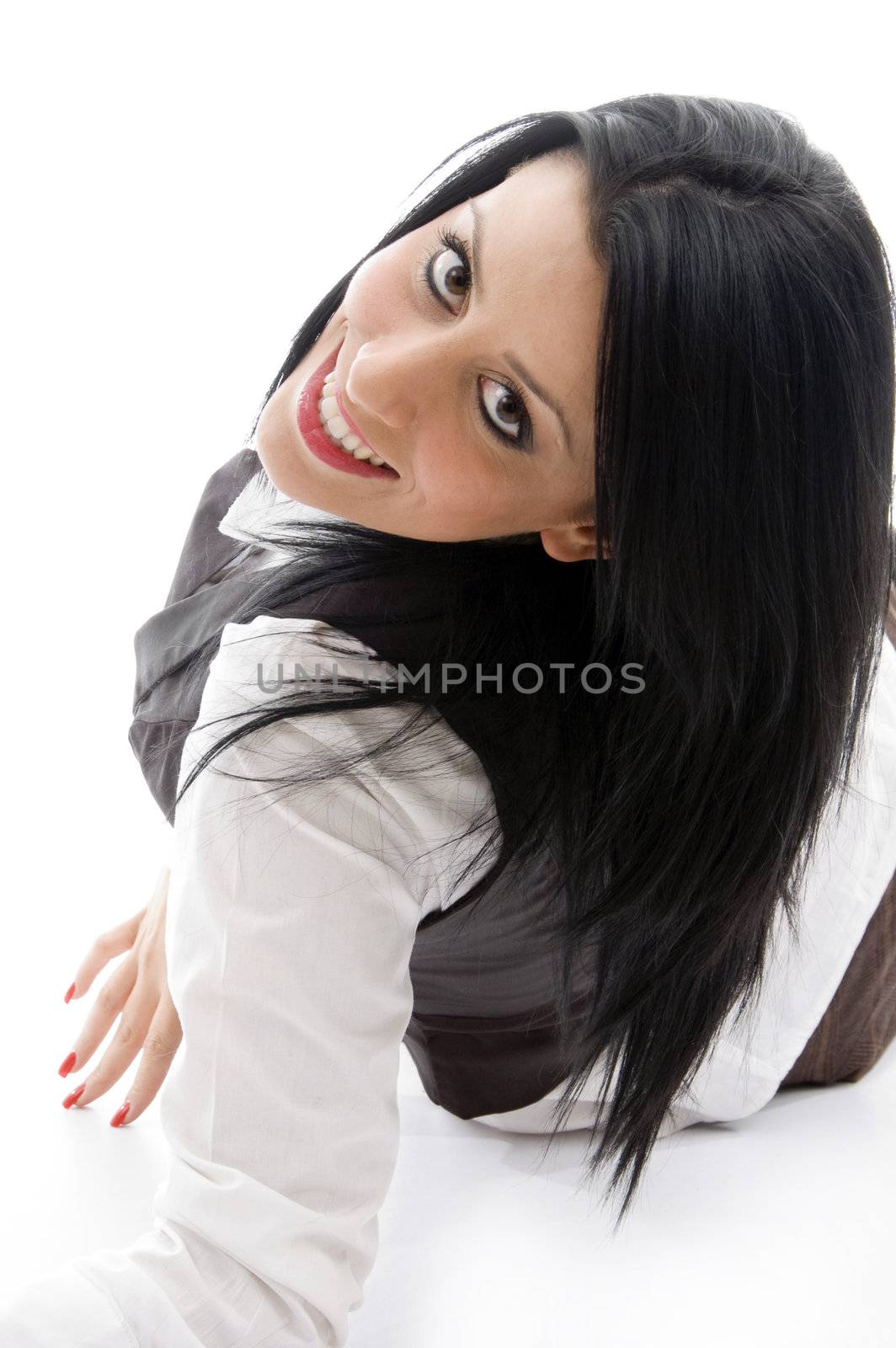 american woman lying on floor and looking backwards with white background