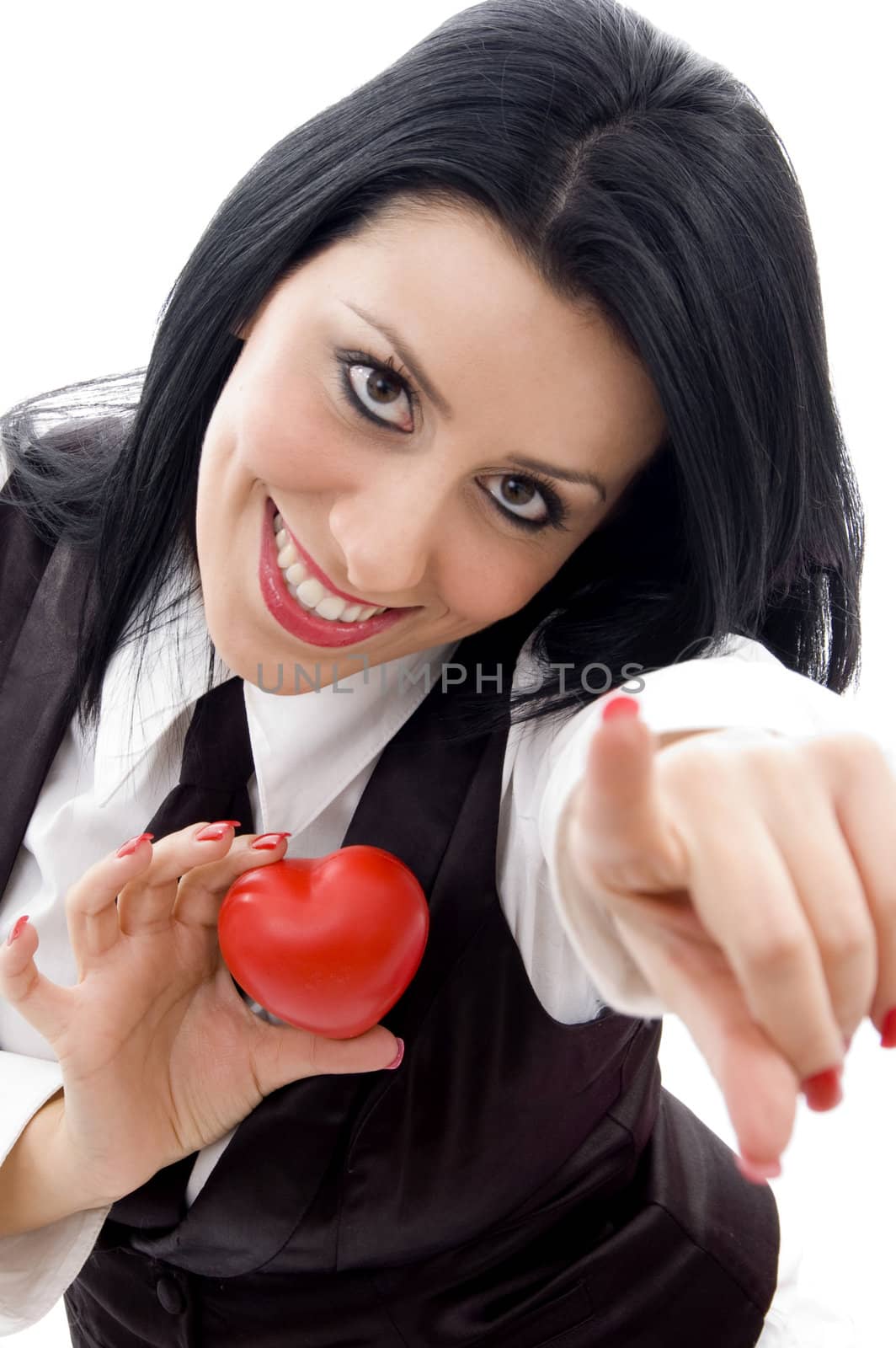 female holding a red heart pointing at camera against white background